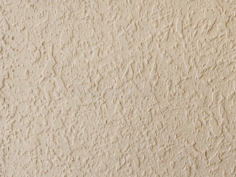 Texture of embossed plaster. Beige stone wall royalty free stock image
