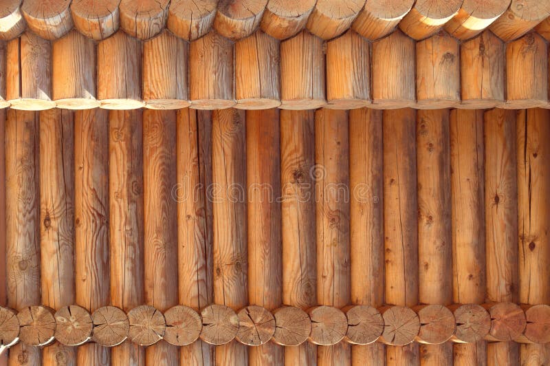 Texture parallel folded treated timber. Ancient technology building of Russian log hut, wood house cottages and churches. Texture in parallel folded logs. The royalty free stock photo