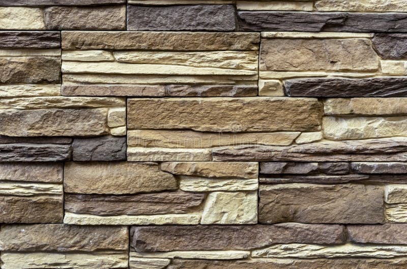 Texture of the stone wall. Panel of stones for finishing the facade of the building and interior design of the house. Background. For design and decoration stock photography