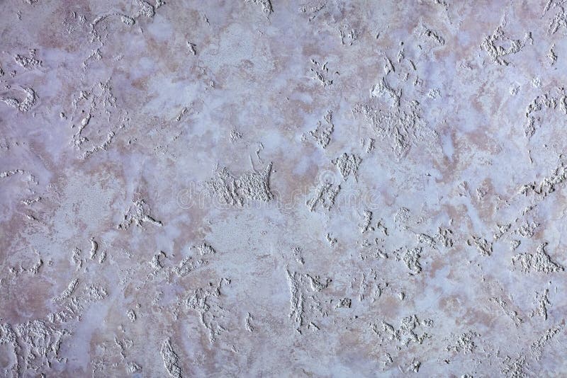 The texture of the Venetian plaster is like a purple granite on the wall stock photo