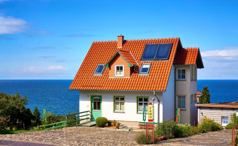 Tourist house on the Baltic Sea in Lohme on the island of Rügen. Apartment, home, solar, panels, roof, tiles, red, architecture, dwelling, residence royalty free stock photo