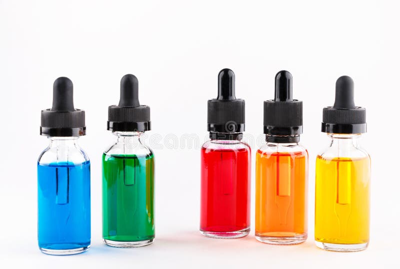 Transparent glass bottles filled colored liquid with dropper stock image