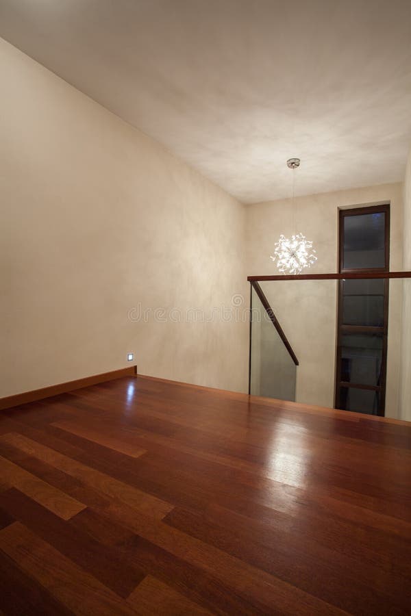 Travertine house - brown wooden floor. Travertine house - vertical view of wooden floor and bright walls stock photo