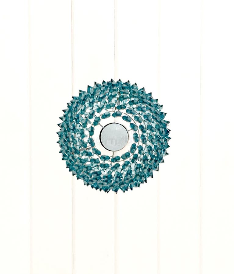 The turquoise, blue lamp on a white wooden ceiling from laths painted by white paint lining, a round chandelier, the bottom view,. Interior design, lighting royalty free stock images