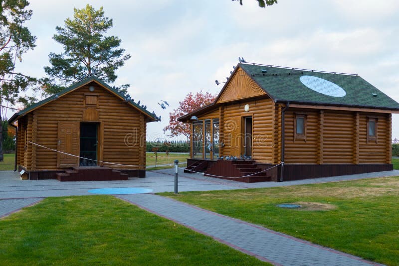 Two houses in the style of an old Russian log hut from wooden decks. For your design royalty free stock photography