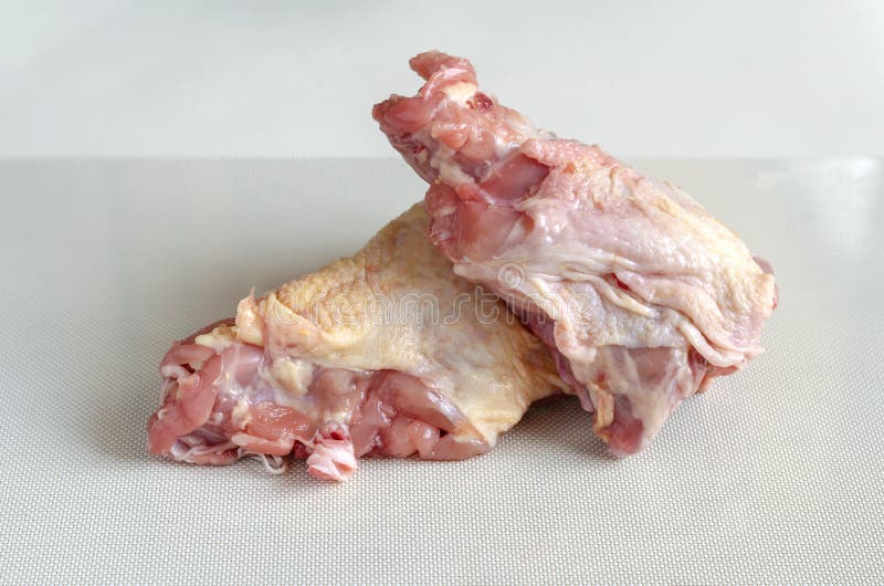 Two raw chicken skeleton closeup. Chicken frames on a white textured background. Two raw chicken skeleton closeup. Chicken meat and offal. Selective focus royalty free stock images