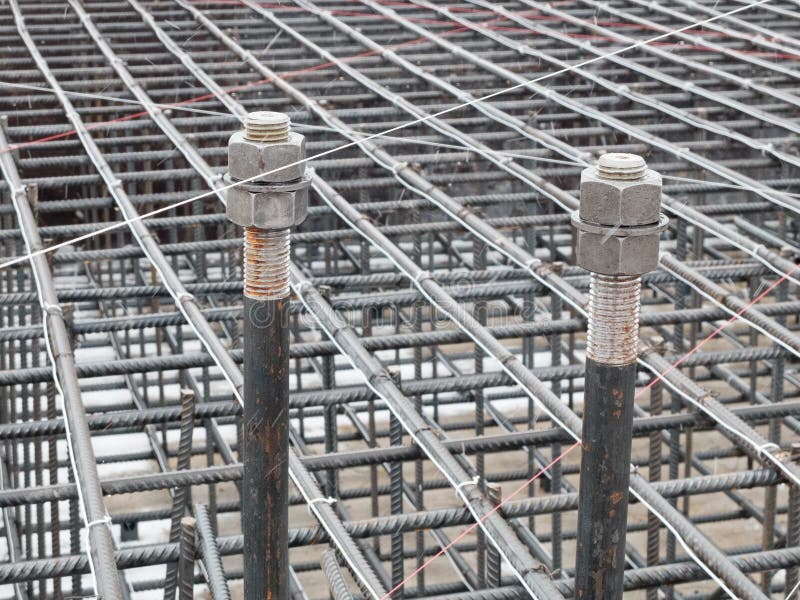 Two steel anchor bolts. With nuts and steel grid on tower crane footing reinforcement stock photos