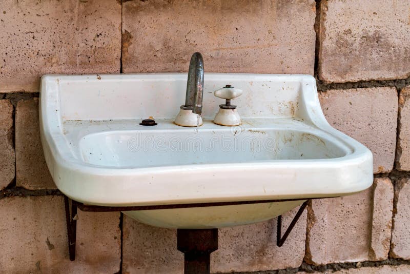 Old dirty sink against brick wall close view royalty free stock photos