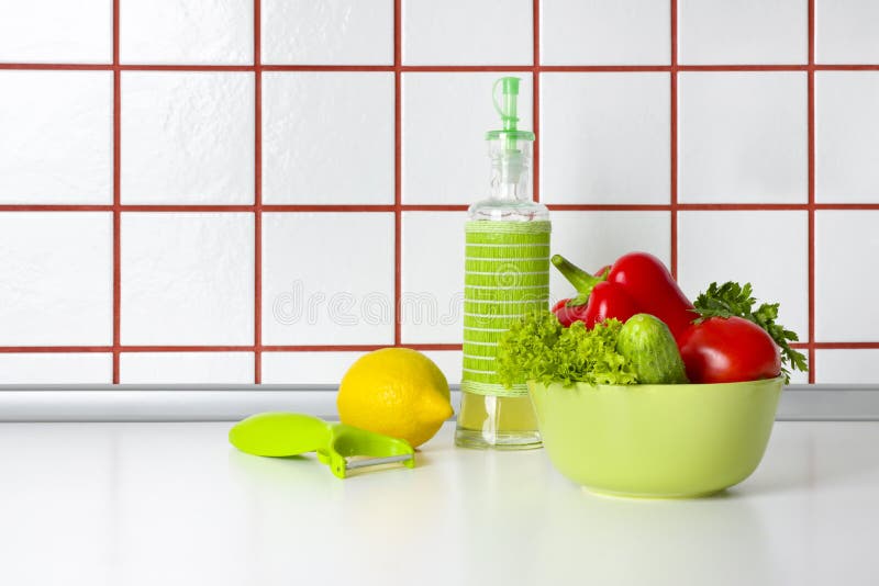 Vegetables, oil and scraper on kitchen counter background.  royalty free stock photos