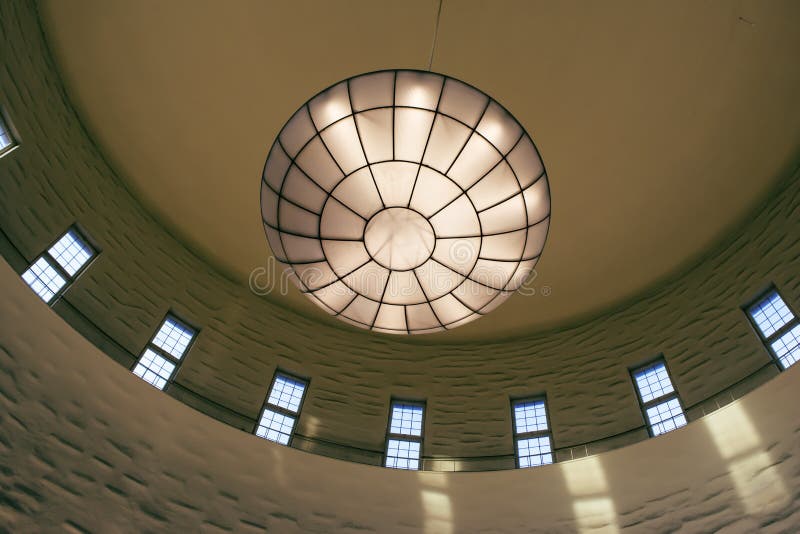 View of huge, beautiful ceiling lamp. In an old library royalty free stock image