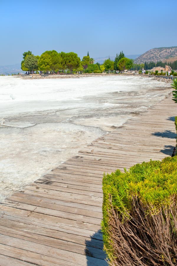 View of the Pamukkale travertine from a wooden floor for the access of tourists.  stock photo