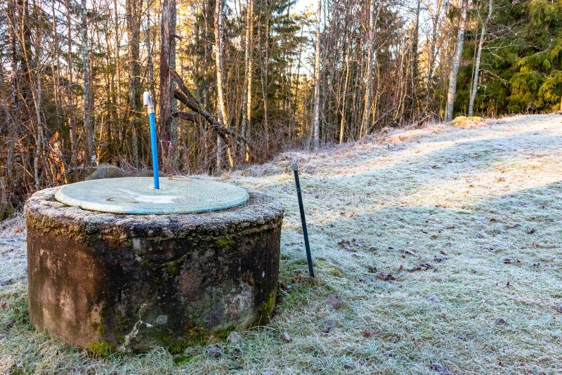 Waste water well made of concrete, covered by a plastic cover with ventilation pipe.  royalty free stock photos