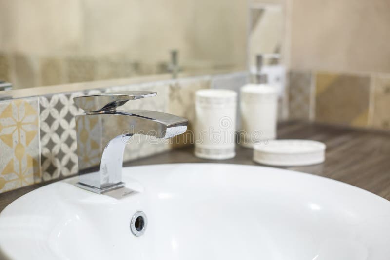 Water tap sink with faucet in expensive loft bathroom.  stock photos