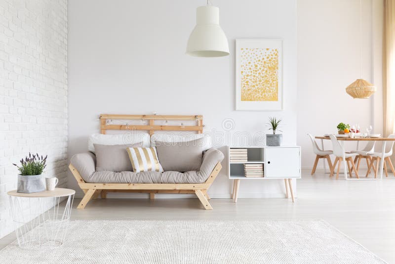 White brick wall in apartment. White brick wall and wooden furniture in apartment stock photos