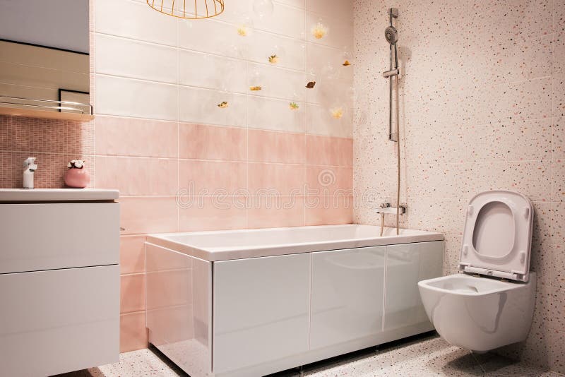 White and pink tones modern bathroom interior with hanging toilet, sink, bath, faucet, mirror, shower, furniture and accessories.  royalty free stock photography