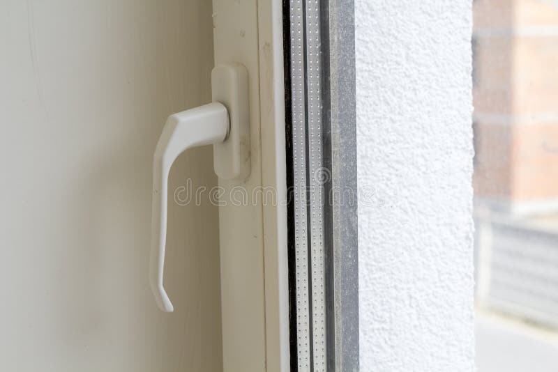 White plastic window or door detail with metal handle and transparent glass on light wall copy space background. Installation and. Design concept stock photo