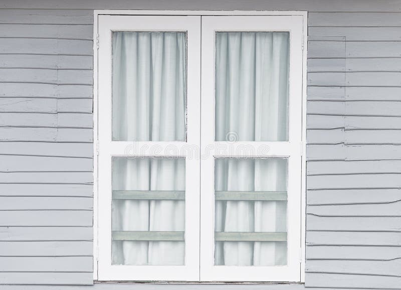 White window doors on old gray wooden houses royalty free stock images