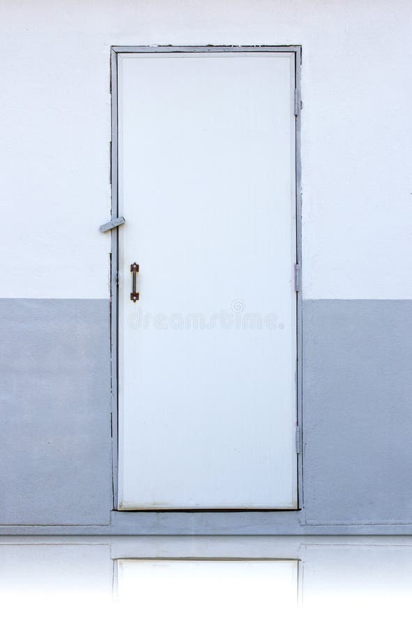 White wooden door on white and gray wall royalty free stock photo