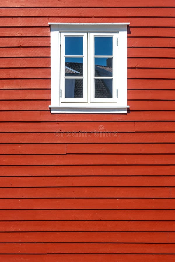 White wooden window on the red wooden house wall. White wooden window on the traditional red wooden house wall, Norway, with copy space royalty free stock photo