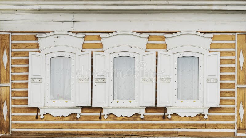 White wooden windows with shutters of an old village house stock images