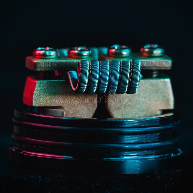 Smokes man vape. Winding close-up for electronic cigarettes from nichrome, fecral. vape. Staggerton Fused Clapton Coil on Dripper for vaping royalty free stock photo