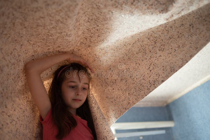 Woman hanging wallpaper motif. Teen girl helps to glue wallpaper on the ceiling. A girl of 9 years helps parents make repairs in the room. Help 