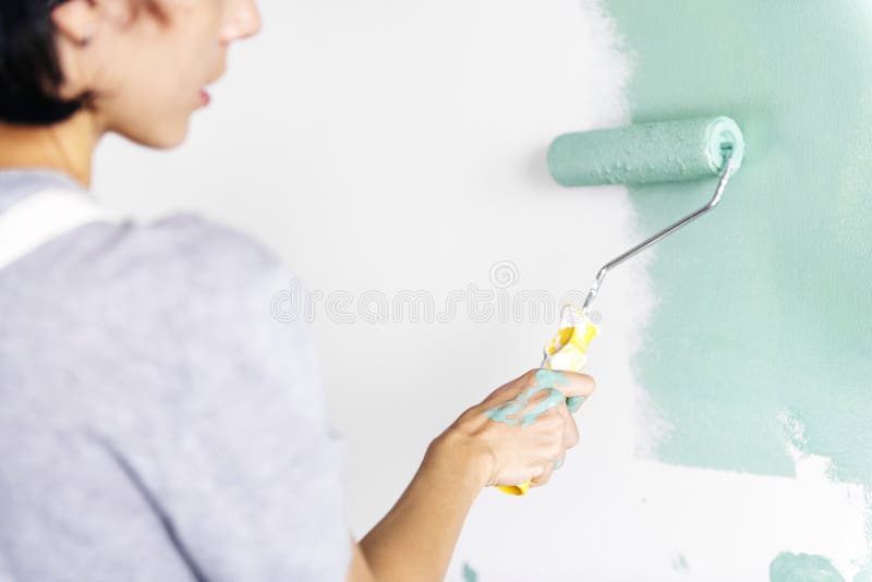 Woman painting an apartment wall royalty free stock image
