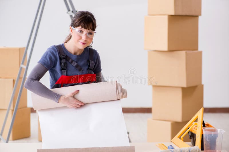 The woman preparing for wallpaper work royalty free stock photos