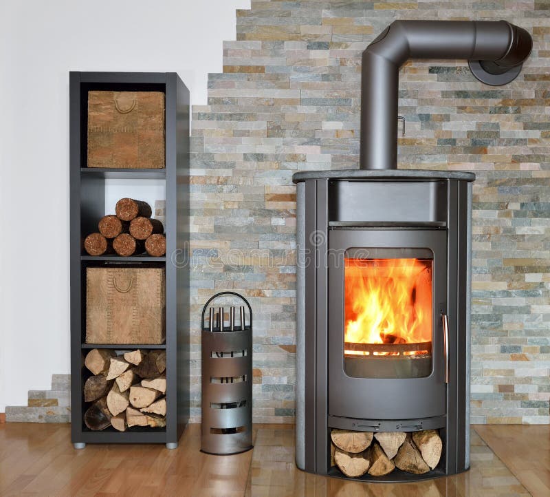 Wood fired stove. With fire-wood, fire-irons, and briquettes from bark stock photo