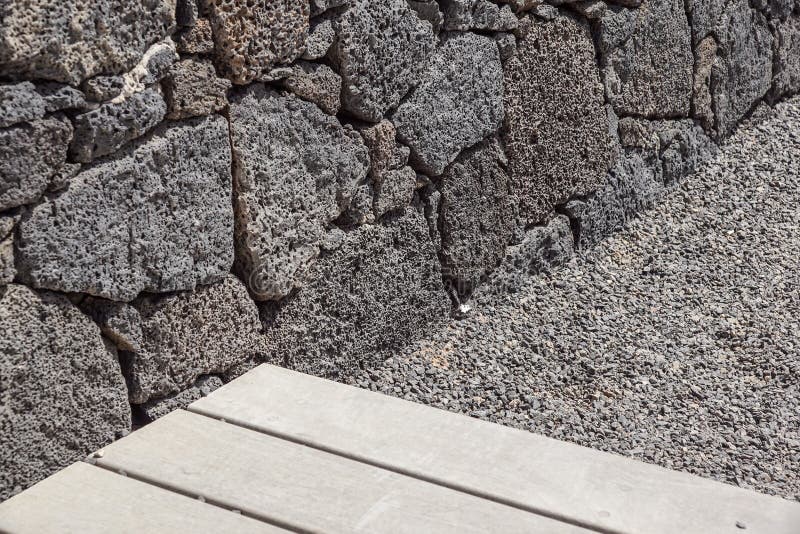 Wood gray floor on the stairs whith stone brick wall.  stock images