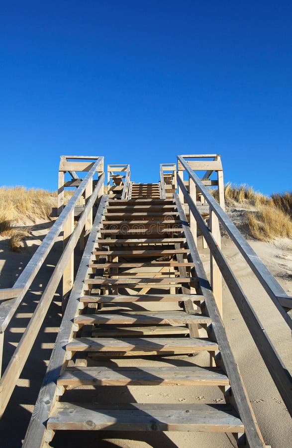 Wood stairs. On a beach and blue sky stock photo
