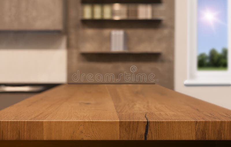 Wood table top as kitchen island on blur kitchen background - can be used for display or montage your products. Mock up for design royalty free stock photography