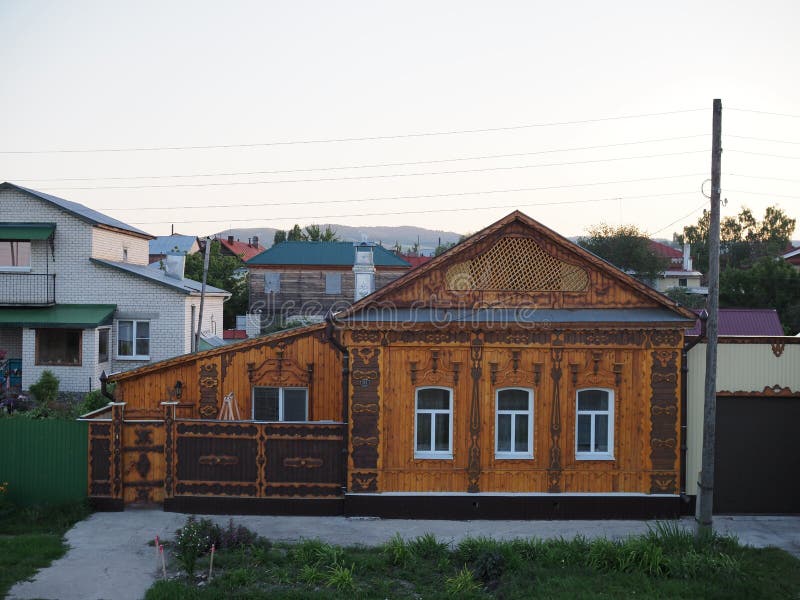 Wooden architecture. Beautiful wooden house with carved decorations on the facade. Russia, khvalynsk - august 2019 royalty free stock photo
