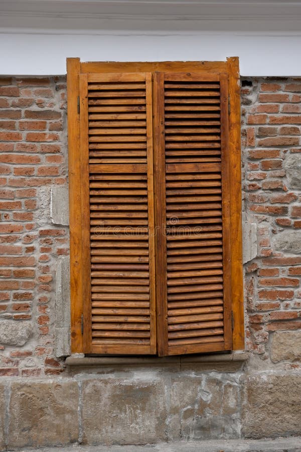 Wooden blinds on windows on the street royalty free stock photo