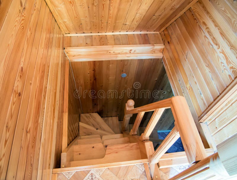 Wooden spiral staircase from the second floor to the first royalty free stock photo