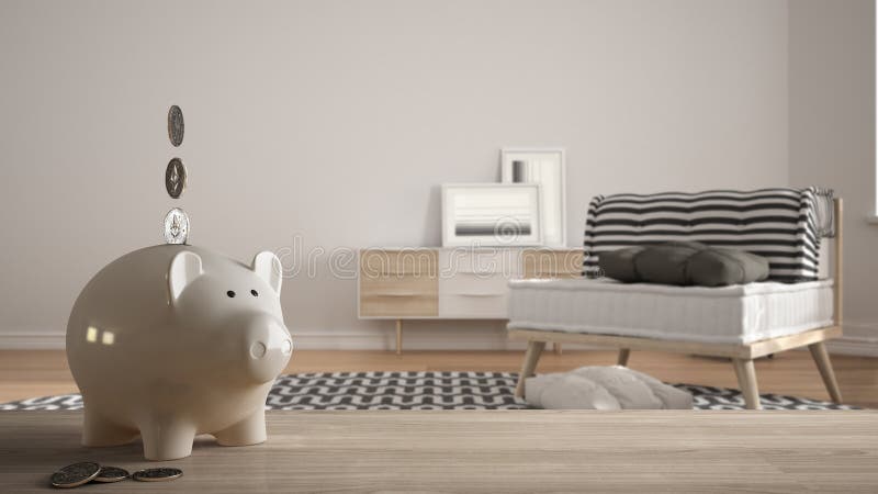 Wooden table top or shelf with white piggy bank with coins, modern white and wooden living room, expensive home interior design, stock image