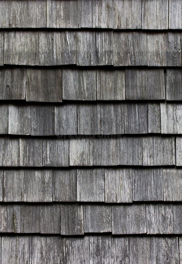 Wooden tile on the roof of house. Wooden tile on the roof of a house royalty free stock photos