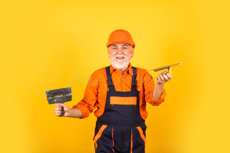 Work for real men. Plastering tools for plaster. plaster trowel spatula on yellow drywall plasterboard. Plasterer in. Working uniform plastering. man with royalty free stock photos