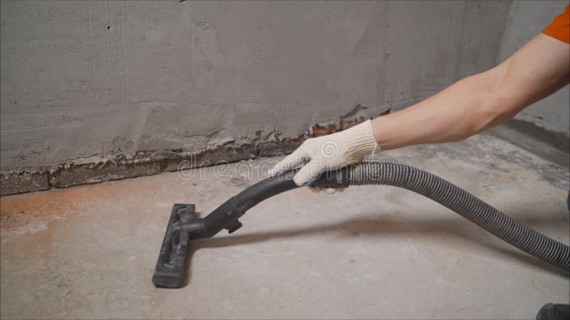 Construction cleaning service sleeve anchor bolt . dust removal with vacuum cleaner. Worker vacuuming concrete floor. Worker vacuuming concrete floor stock images