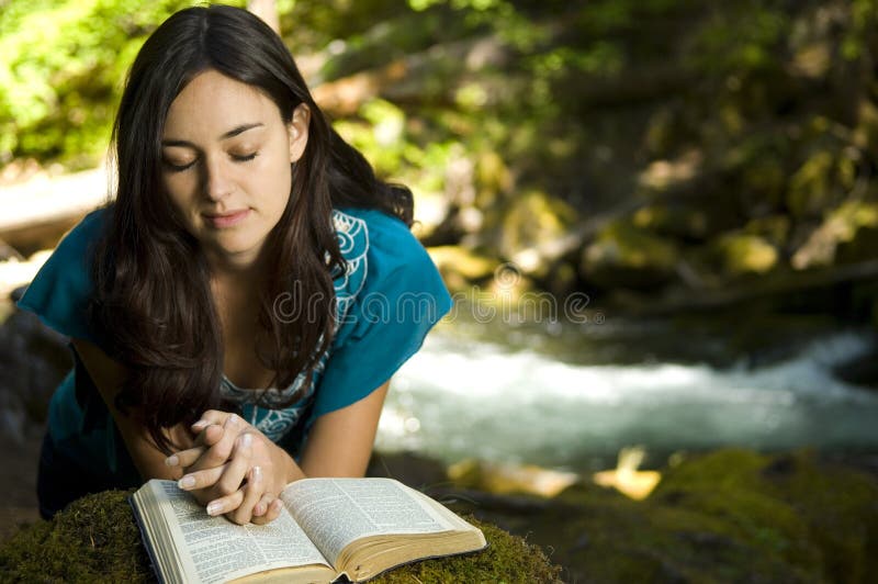 Young woman reading bible stock image