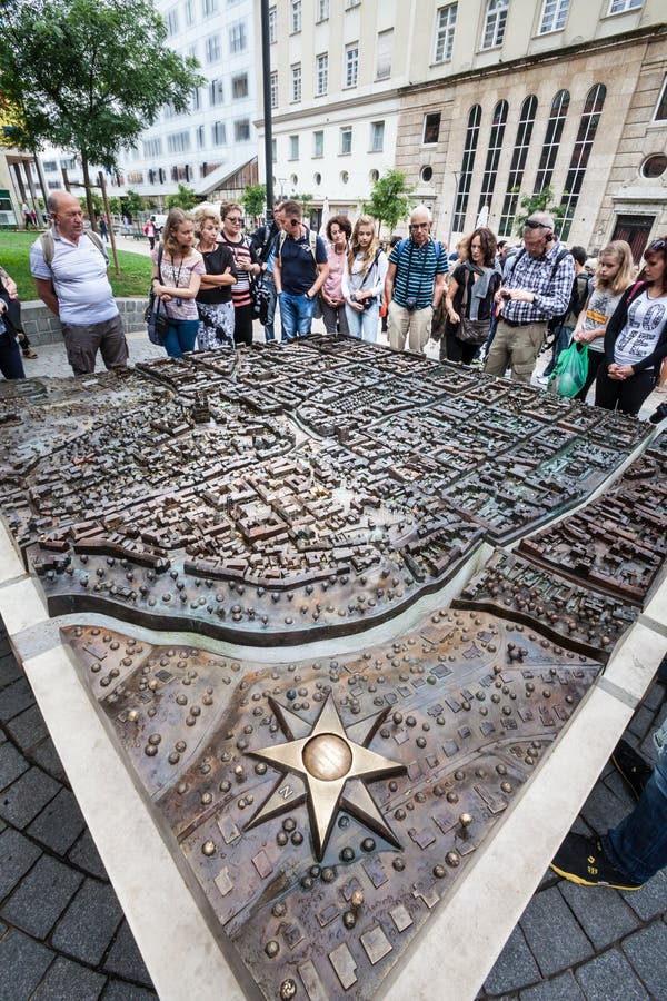 Zagreb, Croatia. 3d floor plan, compass rose and tourists in the historical center. Some Tourists observe gathered the plan in relief of the city of Zagreb in royalty free stock photo