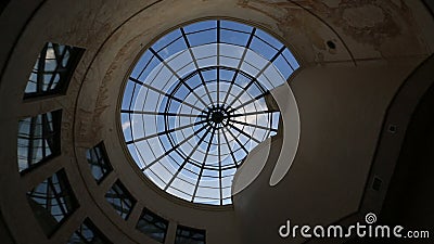 Aerial view at the glass round window in the ceiling of the beautiful building. View of the weather changing from clouds stock video