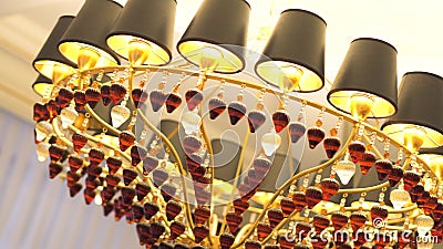 Beautiful chandelier with brown and white pendants under the ceiling with many lamps inside, shooting from the bottom. Beautiful chandelier with brown and white stock video