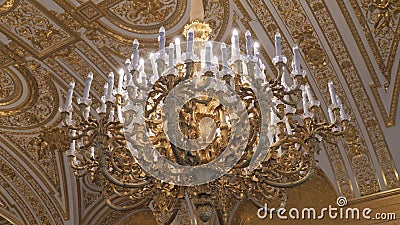 Beautiful large crystal chandelier in a royal environment. Interior elements - decorated ornate ceiling large luxury. Golden chandelier stock footage
