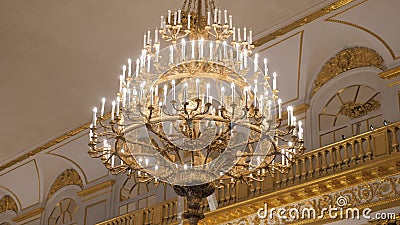 Beautiful large crystal chandelier in a royal environment. Interior elements - decorated ornate ceiling large luxury. Golden chandelier stock video