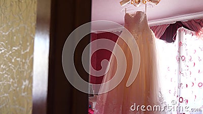 Beautiful white ball gown hanging from the ceiling. fashion concept. White wedding dress hanging in the room to the. Bride on chandelier stock footage