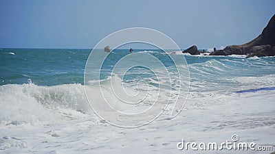 Big beautiful waves roll on an empty sandy beach. A strip of sandy beach. Ocean waves and foam. stock footage