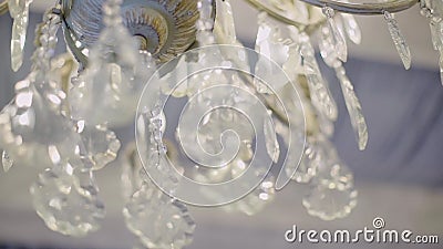 Close-up details of a beautiful glass chandelier under the ceiling. Very close-up. Nice backdrop. Beautiful lighting stock video
