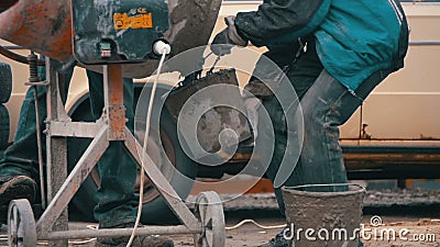 Concrete Mixer Builders and People Working at a Construction Site. Slow Motion stock footage