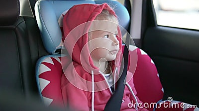 Girl rides in a car in a car seat. stock video